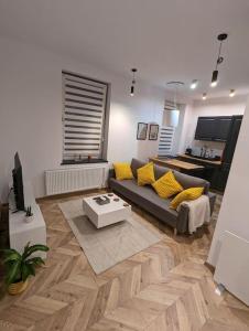 a living room with a couch and a table at Modern apartment close to Katowice Center! in Katowice