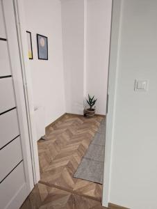 a hallway with a door and a wooden floor at Modern apartment close to Katowice Center! in Katowice