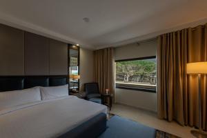 a hotel room with a bed and a window at PC Legacy Hunza in Hunza