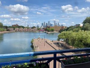 a view of a river with a city in the background at Lovely bright double room-private bathroom in London