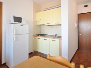 a kitchen with a white refrigerator and a microwave at Apartment in Bibione near Sea Beach in Bibione