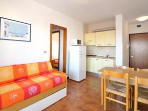 a living room and kitchen with a couch and a table at Apartment in Bibione near Sea Beach in Bibione