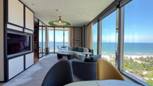 a living room with a view of the ocean at New World Hoiana Beach Resort in Hoi An