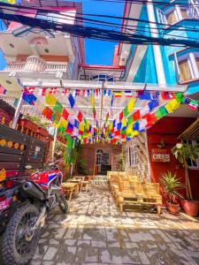 a patio with a table and chairs and colorful flags at Hello KTM Hostel in Kathmandu