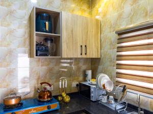 a kitchen with a sink and a counter top at Cozy Apartment - Hideaway with 5G WiFi in Abuja