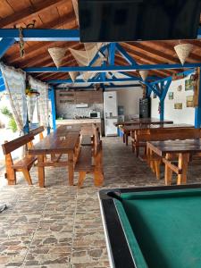 a room with wooden tables and a pool table at Casa Iris Murighiol in Murighiol