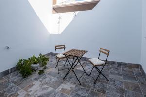 two chairs and a table on a patio at EME SEVILLA TURISTICA in Seville