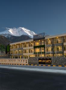 a large building with a mountain in the background at PC Legacy Hunza in Hunza