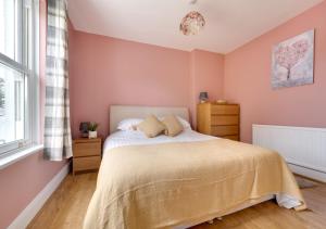 a bedroom with a bed and a window at Llwyncelyn in Llangadog