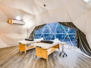 a room with two beds in a tent at Udoscape Eco-Glamping Resorts in Lago Vista