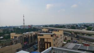 an overhead view of a city with buildings and a highway at Apartement Bogor Icon, View Gunung Salak in Bogor