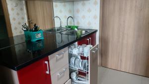 a kitchen with a sink and a counter top at Apartement Bogor Icon, View Gunung Salak in Bogor