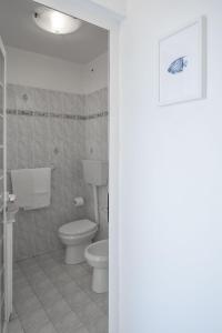 a bathroom with a toilet and a sink at Villa San Pietro in Portovenere