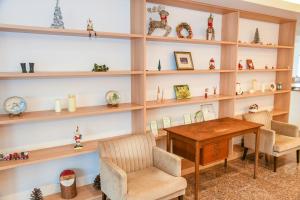 a room with wooden shelves and a table and chairs at Amakusa Santacoming Hotel in Amakusa