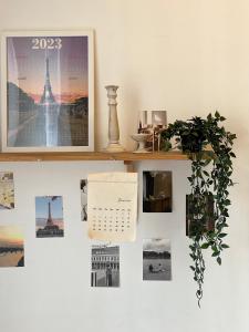 a wall with a calendar and a picture of the eiffel tower at [New] Cozy studio Center of PARIS / Bourse in Paris