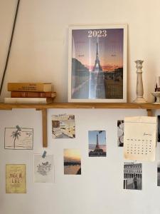 a wall with a calendar and pictures on it at [New] Cozy studio Center of PARIS / Bourse in Paris