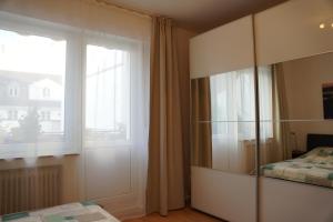 a bedroom with a large glass cabinet and a window at Bright, spacious apartment with a lovely terrace in the heart of Aachen in Aachen
