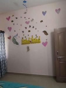 a room with hearts and butterflies on the wall at P. G. REDDY HOME STAY in Tirupati