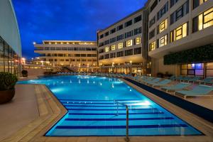 a large swimming pool in front of a building at Kaya Izmir Thermal & Convention in Izmir