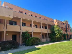 an apartment building with a lawn in front of it at Casa vacanze Collina d'oro in Montagnola