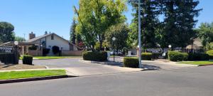 a street in a residential neighborhood with a house at Townhouse Suite by FSU SaveMartCenter in Fresno
