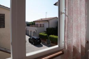 a car is parked outside of a window at Casa Le corti in Livorno