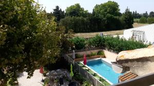 an overhead view of a swimming pool in a garden at le Mas d'Hubert in LʼIsle-sur-la-Sorgue