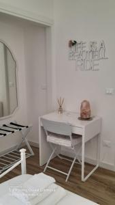 a room with a white desk and a mirror at B&B Casa Alinella, Happy and Sustainable Hospitality in Taranto