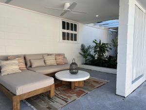 a living room with a couch and a table at Modern Pool Oasis & Seaside Abode in Brighton