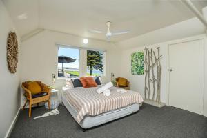 a bedroom with a bed and a window at Pine Beach Villa Fabulous Sea Views in Victor Harbor