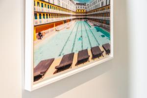 une peinture d'une piscine dans un bâtiment dans l'établissement LE BOSTON - Hypercentre - 150 M 2- 7 Guest, à Dijon