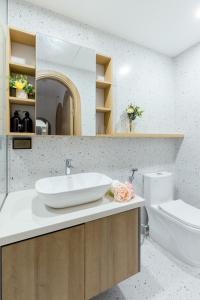 a bathroom with a sink and a toilet at Crescendo Boutique Studio - STAY 24h in Hanoi