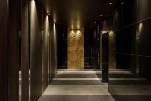 a hallway of a building with a brick wall and lights at the b namba-kuromon in Osaka