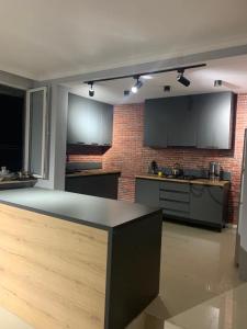 a kitchen with a counter and a brick wall at Guest House Kobuleti on Aghmashenebeli in K'obulet'i