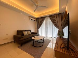 a living room with a couch and a table at Luxury 2Bedroom R&F Princess Cove @By Hauz Cinta in Johor Bahru +5 photos