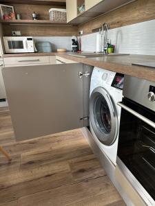 a kitchen with a washing machine in a kitchen at WE Apartment - close to the center & city view in Banská Bystrica