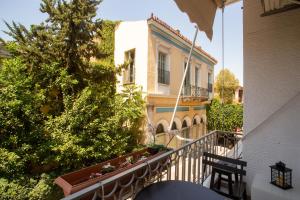a balcony of a house with a building at Hadrian by Heloni Apartments in Athens