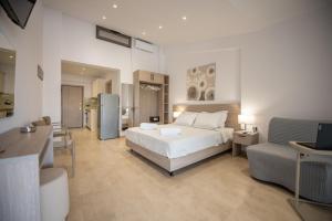 a bedroom with a bed and a desk and a couch at Casa de Lapel Kallithea in Kallithea Halkidikis