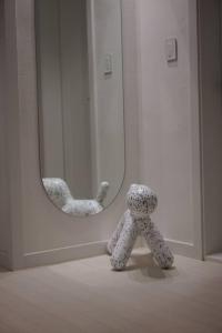 a teddy bear standing in front of a mirror at Dawn House in Seoul