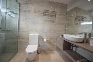 a bathroom with a toilet and a sink and a shower at Casa de Lapel Kallithea in Kallithea Halkidikis