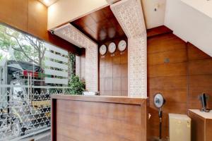 a pivot door in a room with a glass wall at Pine Tree Signature in Chennai