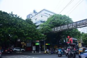 a group of people riding motorcycles on a city street at Pine Tree Signature in Chennai