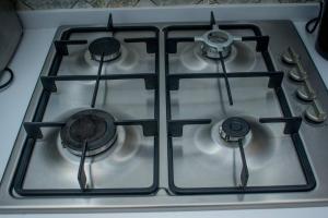 a stove top with four burners on top of it at Urban Lifestyle 1BR in Westlands, Heated Pool, Gym, Workspace & Parking in Nairobi