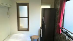 a small room with a bed and a window at COTE sakuragawa "Room 201,301,401" - Vacation STAY 03134v in Osaka