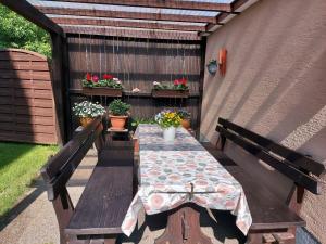 a table and benches on a patio with flowers at Ferienwohnung Schallinger in Teisendorf