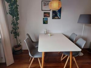 a white table and chairs in a room with a plant at Ferienwohnung Schallinger in Teisendorf