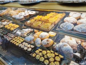 a display case filled with lots of different types of donuts at Case vacanze LE ROSE in Campofelice di Roccella