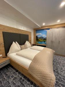 a bedroom with a large bed with a large window at Sun Chalet in Schladming