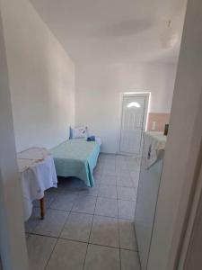 a room with a bed and a table and a door at Fully equipped apartment in Apokoronas in Nípos