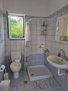 a bathroom with a toilet and a sink and a tub at Fully equipped apartment in Apokoronas in Nípos